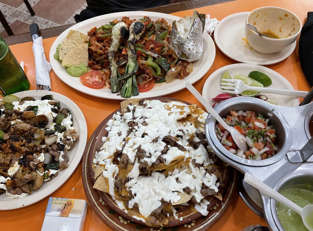 a table full of fajitas, Mexican tacos, tacos and more at El Fogon in Playa Del Carmen 