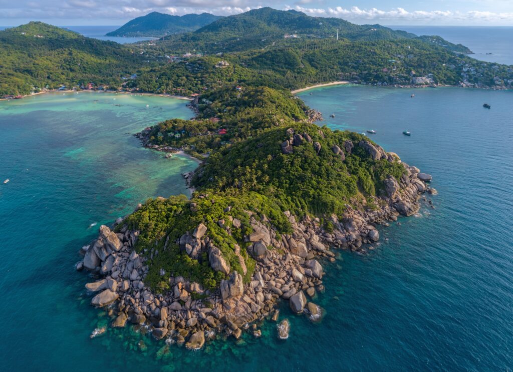 aerial views of luscious green forest along the coastline of Koh Tao island in the Gulf of Thailand