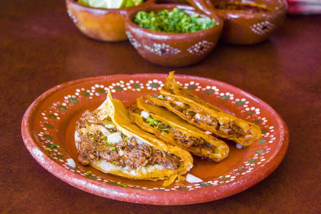 crispy Birria tacos full of meat and cheese being served at Los Hjos de la Birria in Playa Del Carmen
