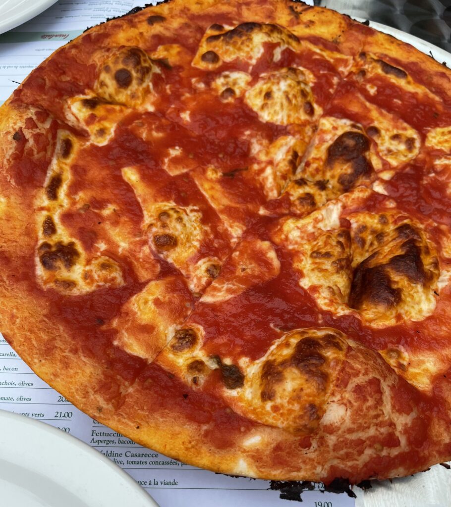 pizza pie being served at an Italian restaurant in Montreal
