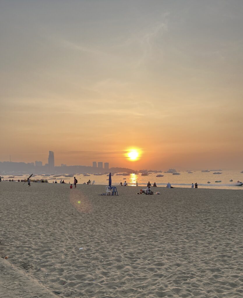 sunset in the distance on a empty beach in Pattaya City
