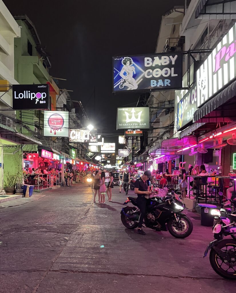 busy street in Pattaya City full of motorbikes and gogo dancers, bars and nightclubs