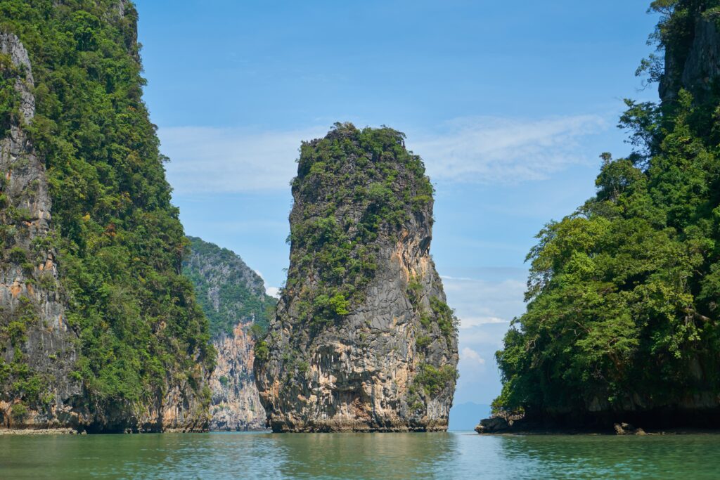 large rock limestone rock formations along the water in Phang Nga Bay, one of the most famous Phuket day tours
