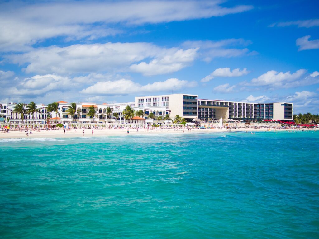 turquoise blue waters showing a Playa Del Carmen beach shoreline from the ferry between Cozumel to Playa Del Carmen