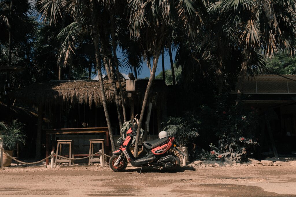 scooter parked on the side of the road in Tulum, Mexico