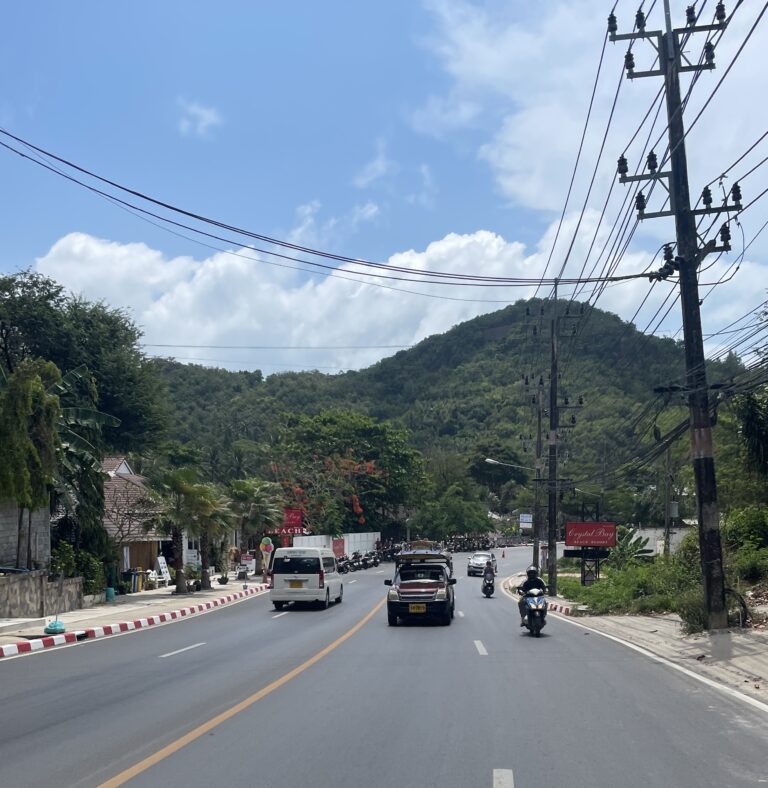 streets of Koh Samui on the main road along with mountains and clear skies in the background / Koh Phangan to Koh Samui