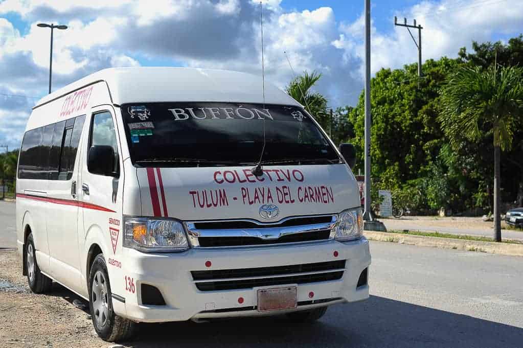 white colectivo van parked on the side of the street in Mexico 