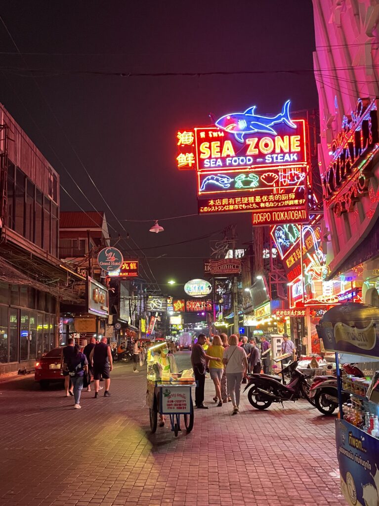 well-lit lights of bars, strip clubs, nightclubs and several tourists along the famous Walking Street in Pattaya City