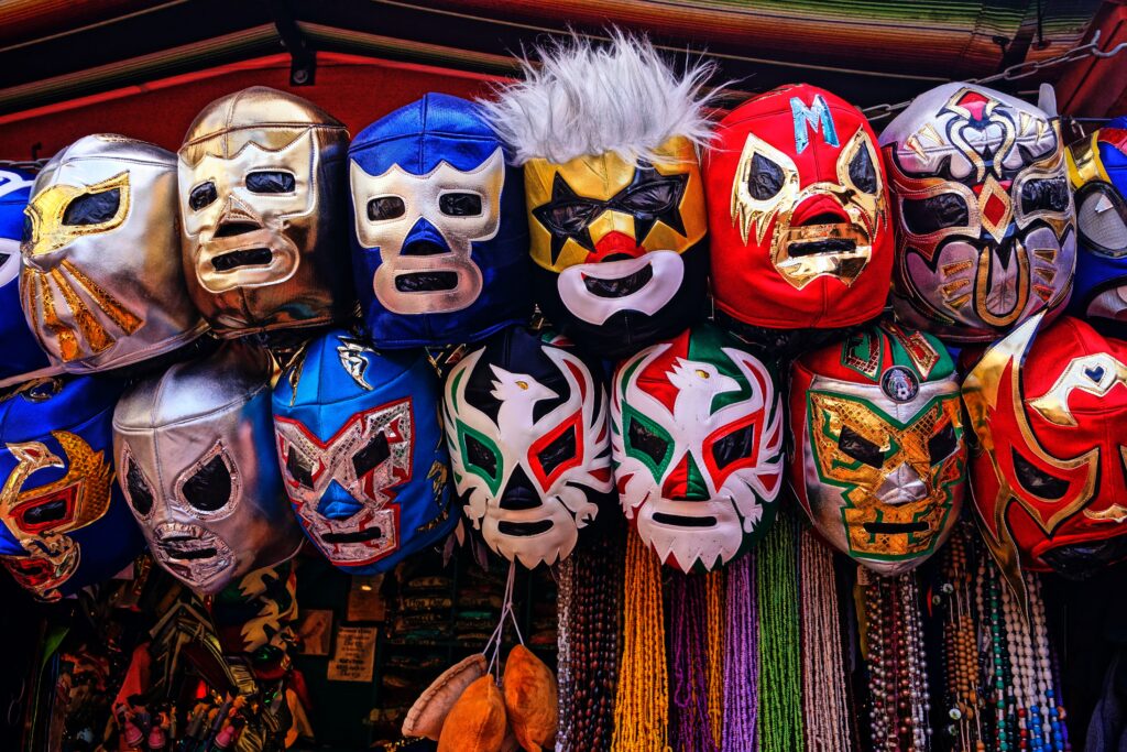 several lucha libre masks hung up being sold by a vendor 