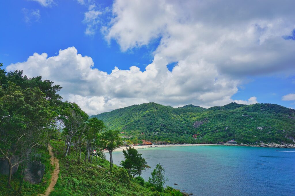 mountainous ranges and clear skies along the ocean in Koh Phangan, Thailand