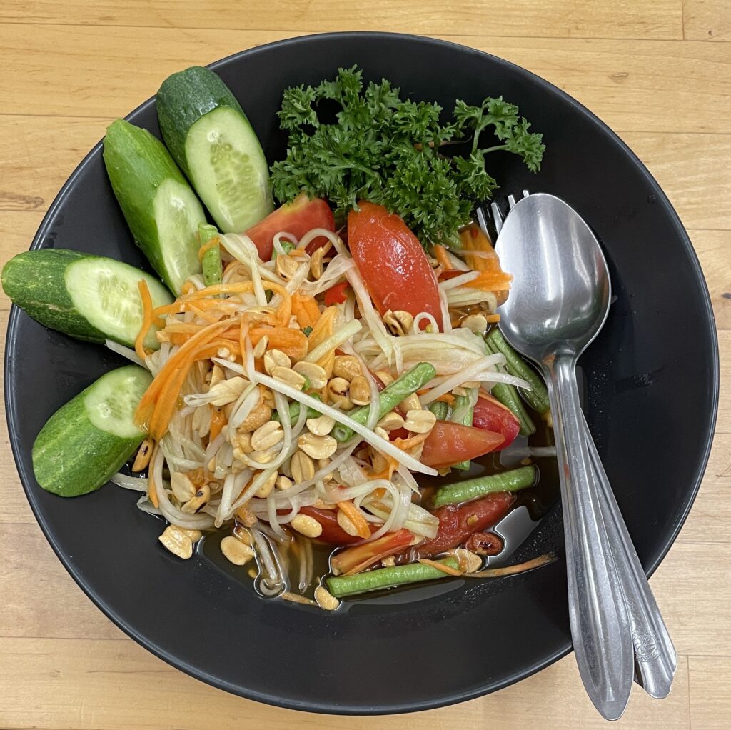 a plate of papaya salad being served in Phuket