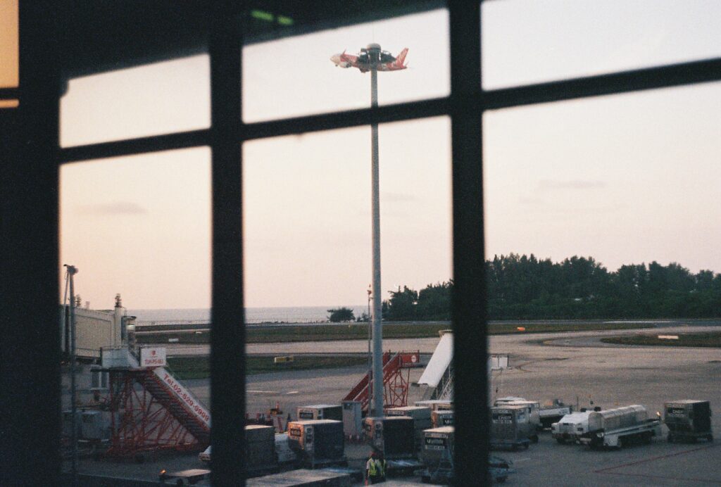 plane leaving Phuket International Airport from tarmac