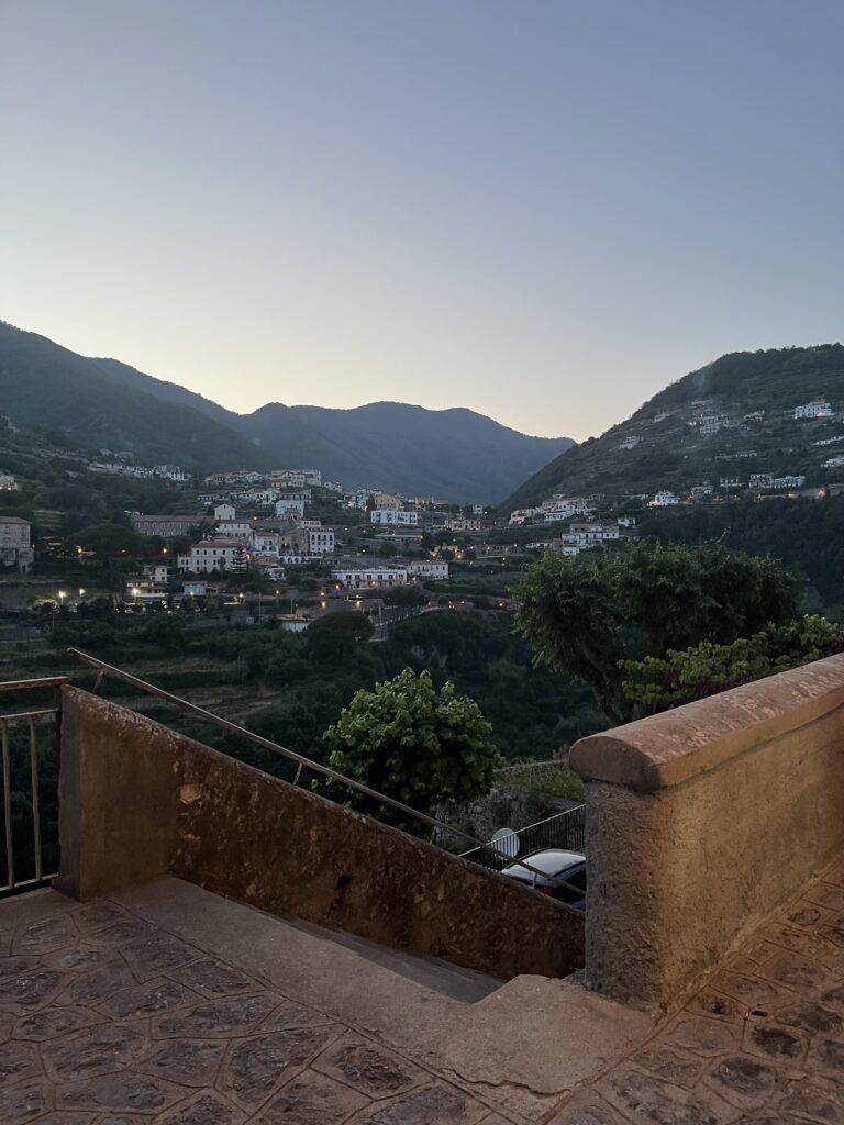 walkway steps by a terrace viewpoint showcasing the hills full of homes and mountains in Ravello