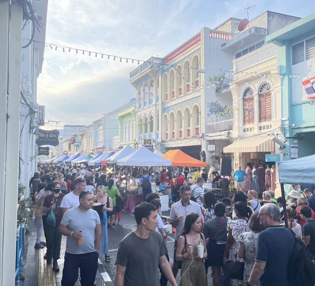 Several tourists walking on Thalang Rd for the Old Phuket Town Sunday night market