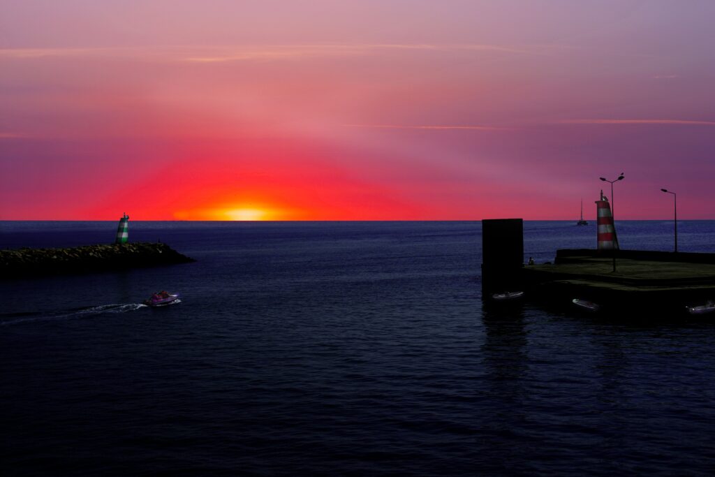 vibrant pink and orange sunset setting in Lagos, Portugal