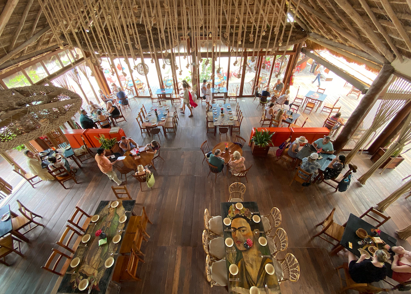 high ceiling and decorated tables with a Mexican flare at La Zebra Restaurant in Tulum, Mexico 