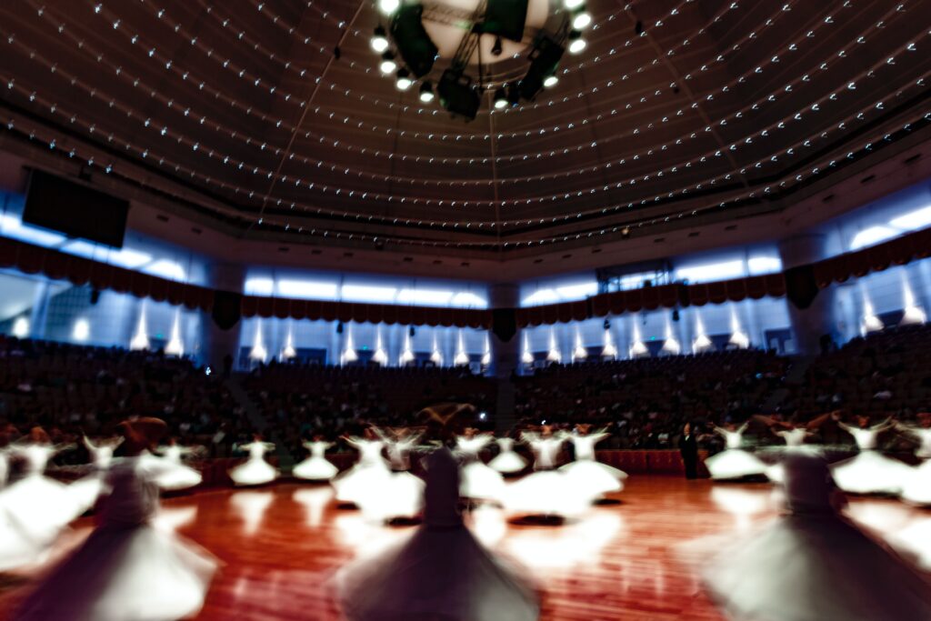 several men performing the swirling dance of devout in Konya, Turkiye one of the cheapest cities in Turkey to visit 