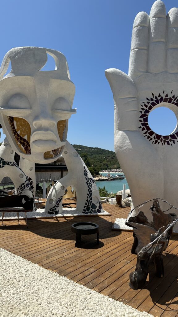 large art sculptures on a boardwalk in Ksamil