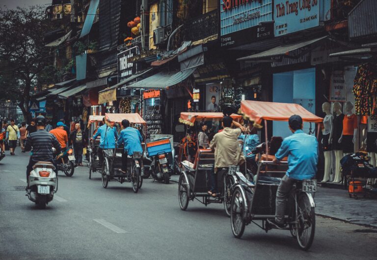 many locals riding scooters and bikes through the streets in Vietnam / cheapest places in Vietnam to visit