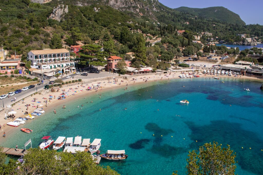 views of beautiful beach shoreline in Corfu, Greece full of many beach goers
