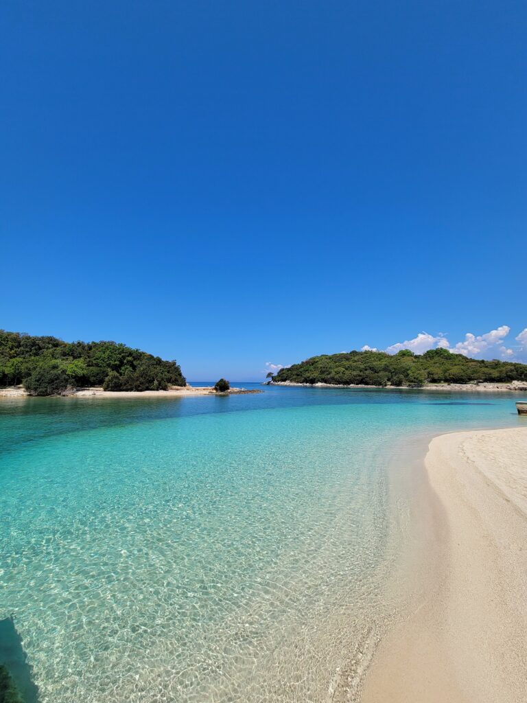 crystal clear waters and several small islands nearby in Ksamil, Albania 