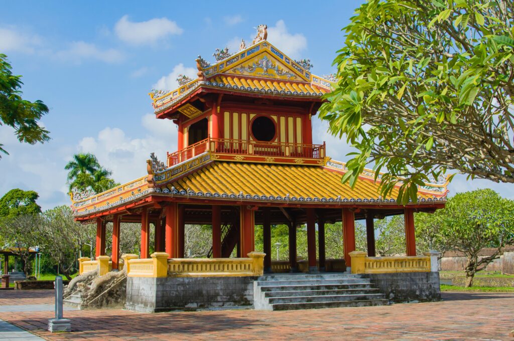 bright coloured temples amongst forests in Hue, Vietnam