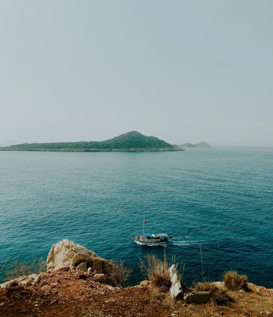 views of a island and a boat sailing on by from a high up viewpoint in Kas 