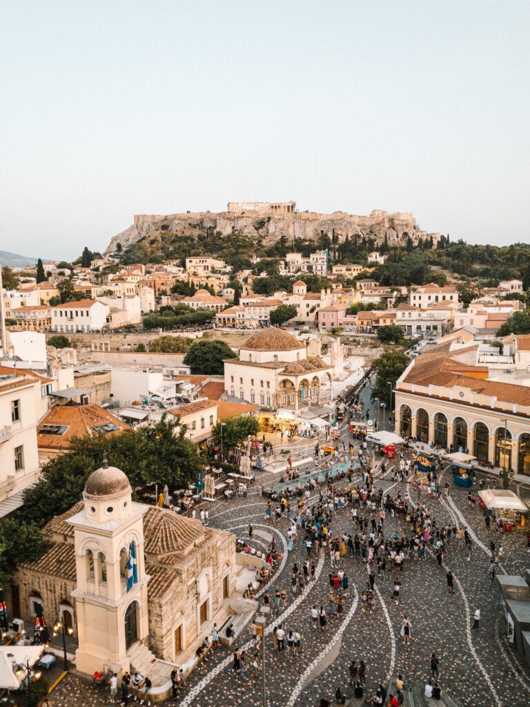 aerial shot showing the famous Monastiraki Square full of many tourists walking and shopping in Athens, Greece 