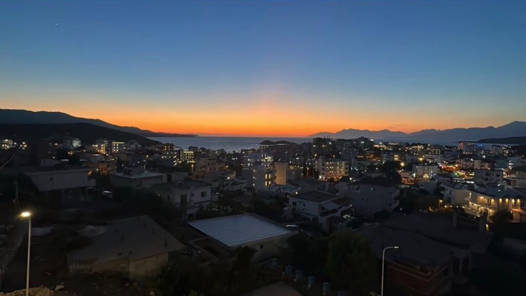 sunset setting in amongst the town of Ksamil 