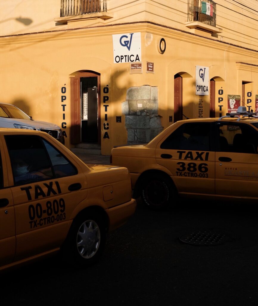 two taxis driving on the busy streets in Mexico 