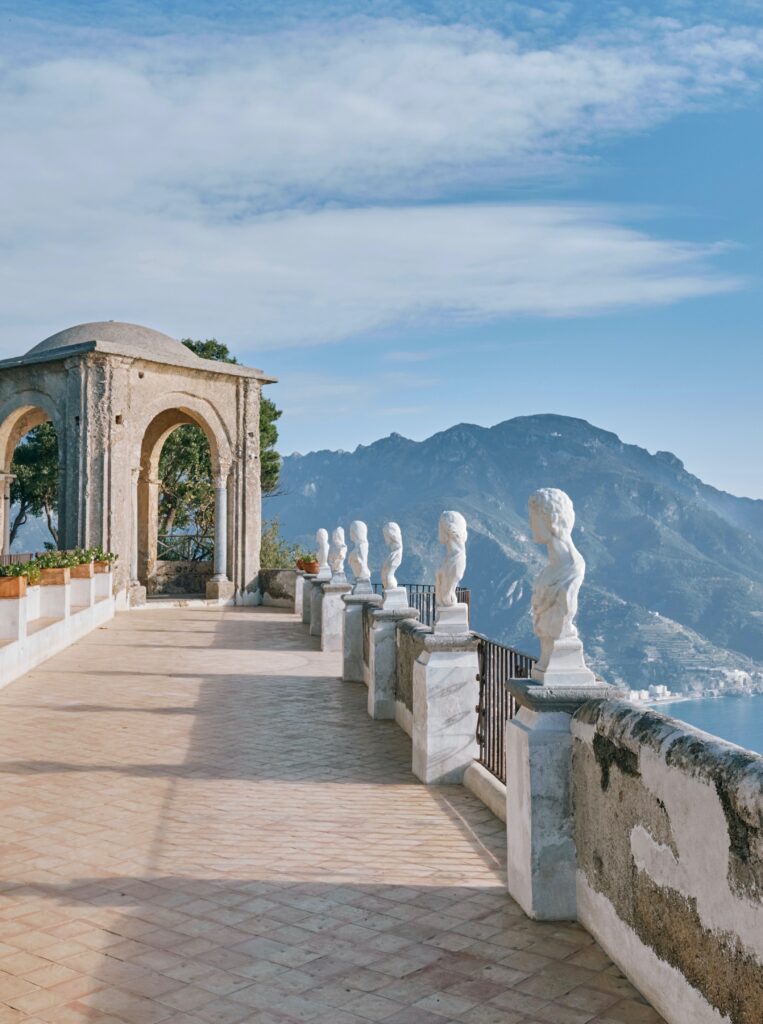 marble sculptures sitting along railings on the terrace with exceptional sea views from Villa Cimbrone in Ravello, Italy 