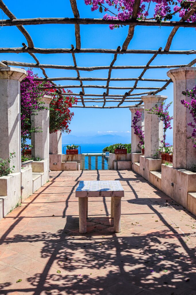 dreamy walkway full of flowers showing amazing panoramic sea views from Villa Rufolo in Ravello, Italy 