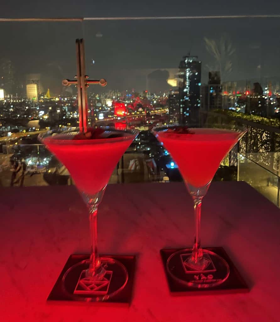 two cocktails being served on a popular rooftop bar in Bangkok, Thailand