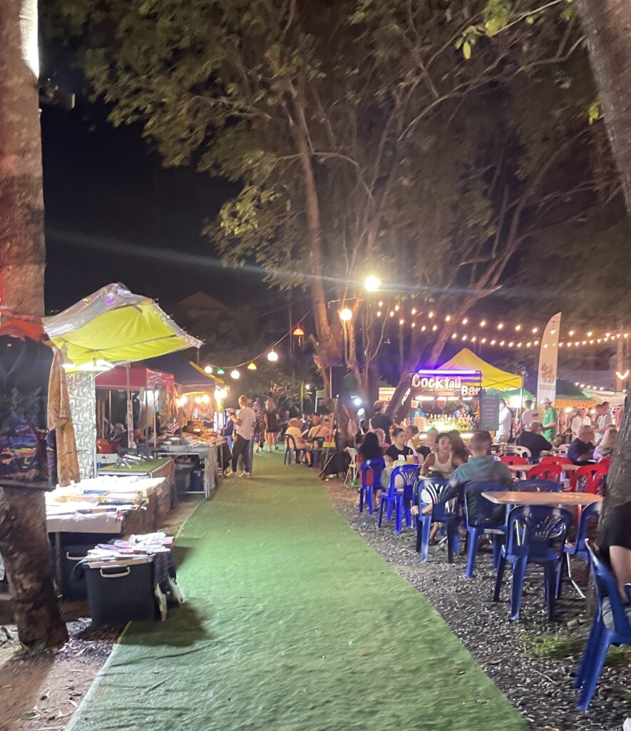 several locals and tourist seated eating many different foods at the Fisherman's Night Market in Koh Samui, Thailand