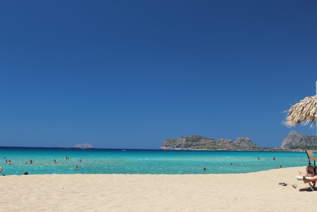 several tourist swimming in the multi-hued turquoise waters of Crete, Greece