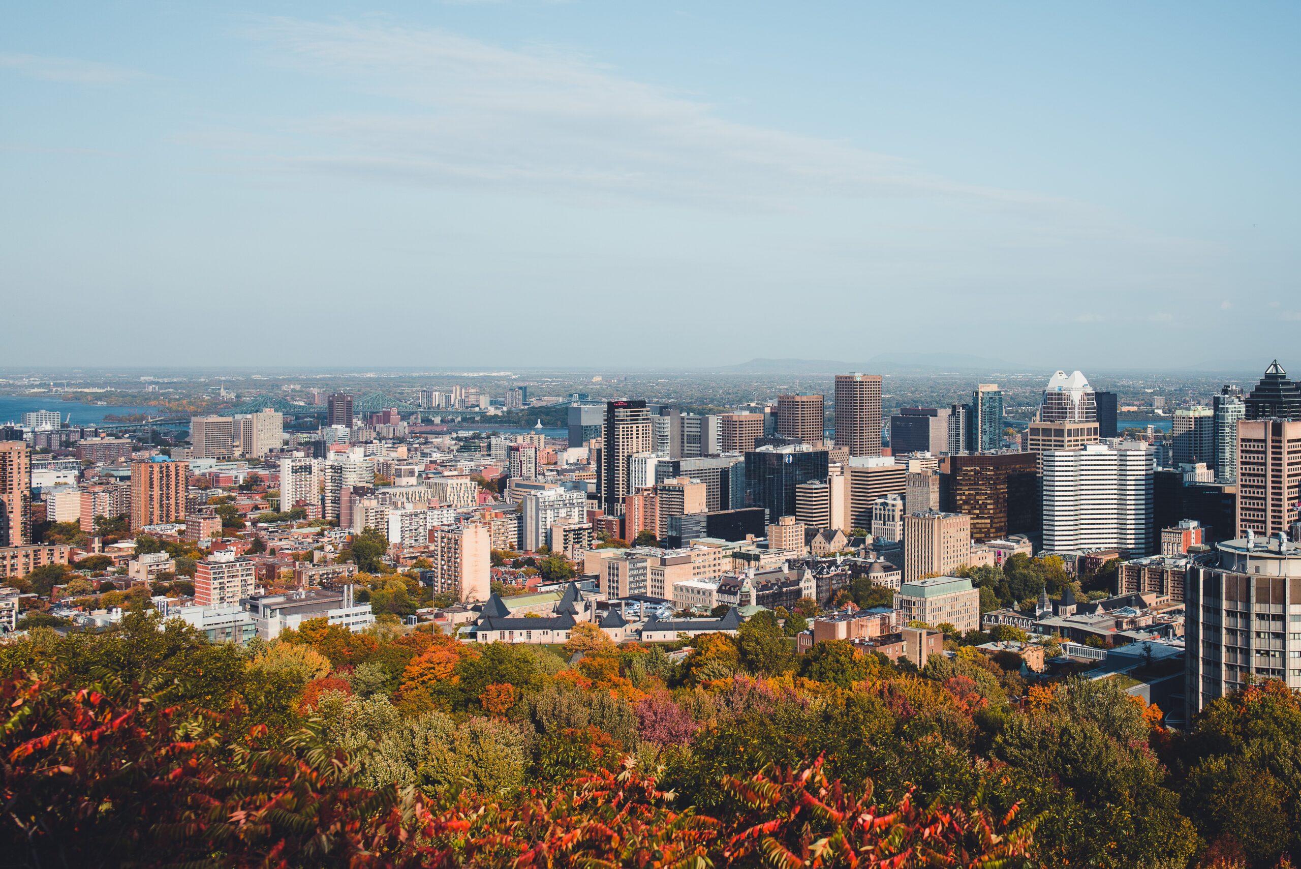 views of the Montreal skyline during Fall time, how to get from Toronto to Montreal