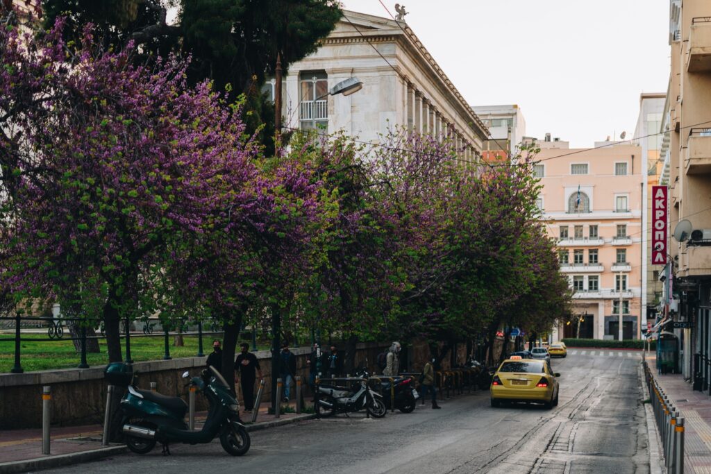 taxi driving down a picturesque cobblestone road in Athens, Greece