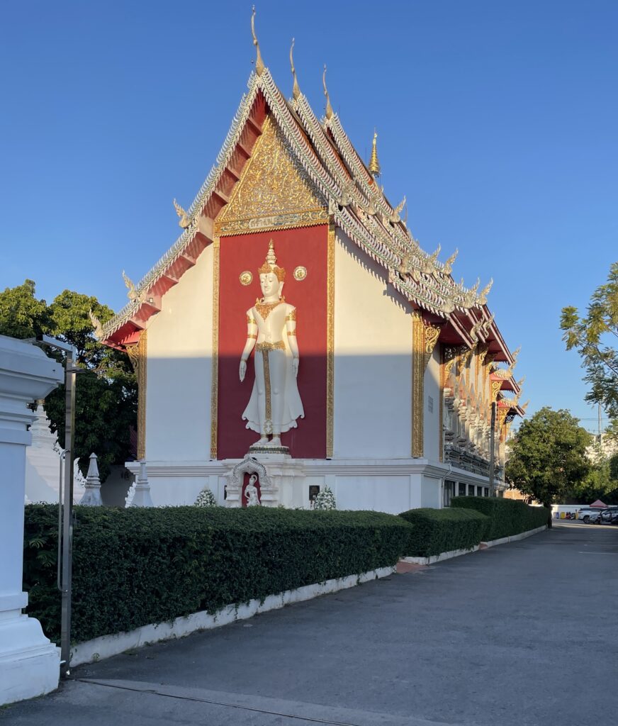 a beautiful temple with the sun shining on it in the evening in Chiang Mai, Thailand