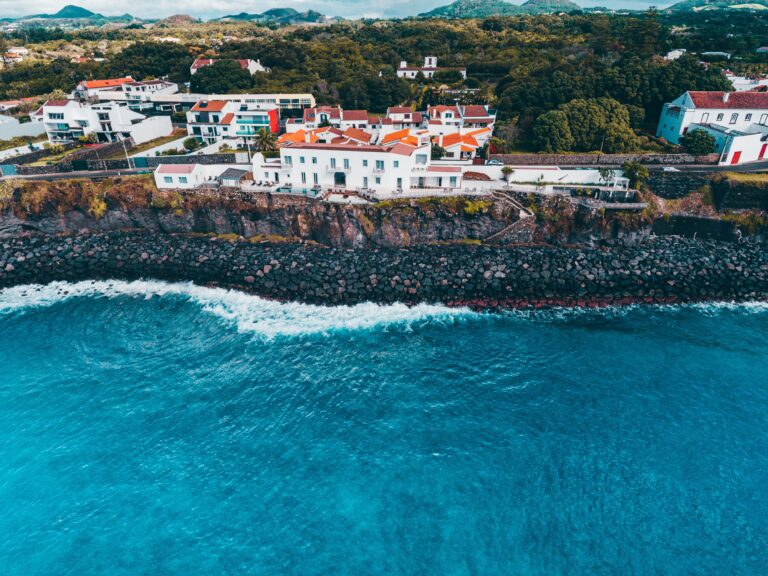 aerial views of many beautiful old buildings and coastline in Ponta Delgada, Portugal / Cheapest Cities in Portugal