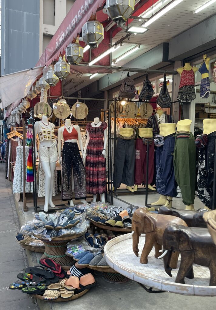 various bohemian clothing, hand crafted wooden elephants and more being sold at the Night Bazaar in Chiang Mai 