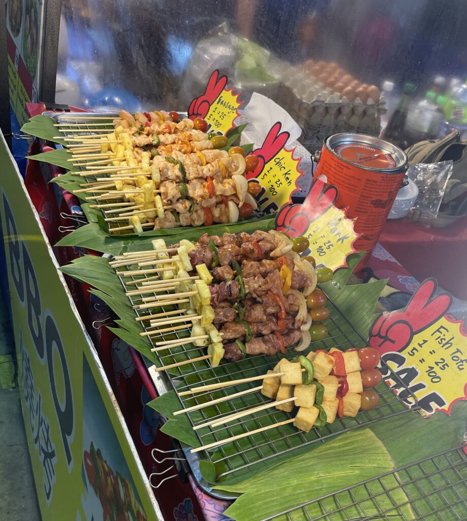 meat skewers being sold by a vendor at the a Chiang Mai night market