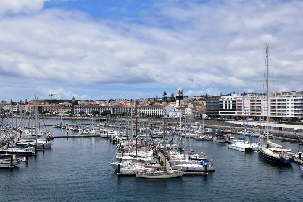 several sail boats docked at the main harbour in Ponta Delgada, Portugal