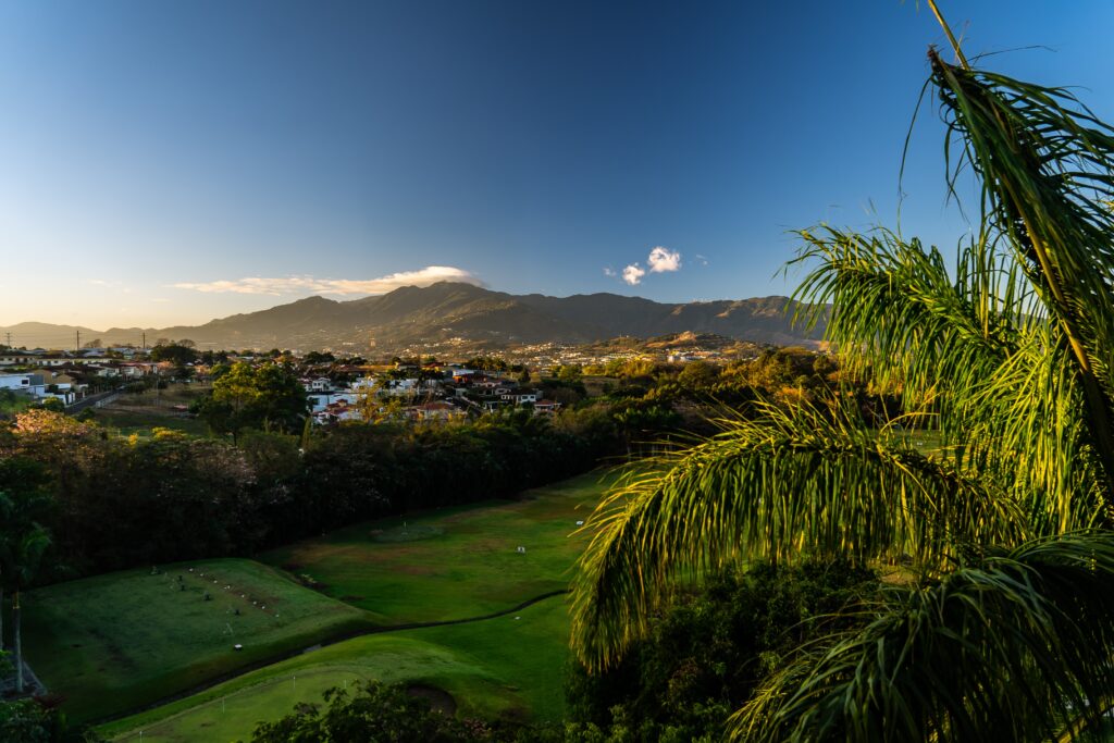 stunning picturesque scenery of luscious  greenery and mountains on a clear sky day in San Jose, Costa Rica