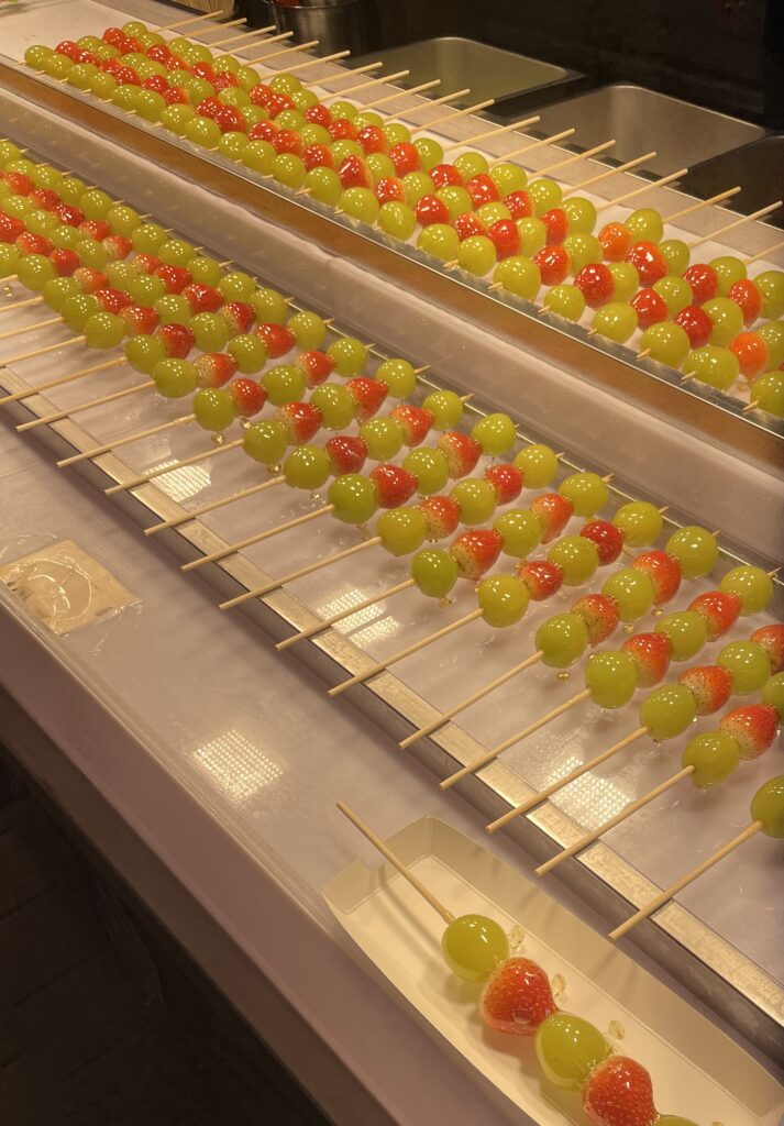 rows of sugarglazed fruits at a vendors stall at the Myeongdong Night Market in Seoul, Korea 
