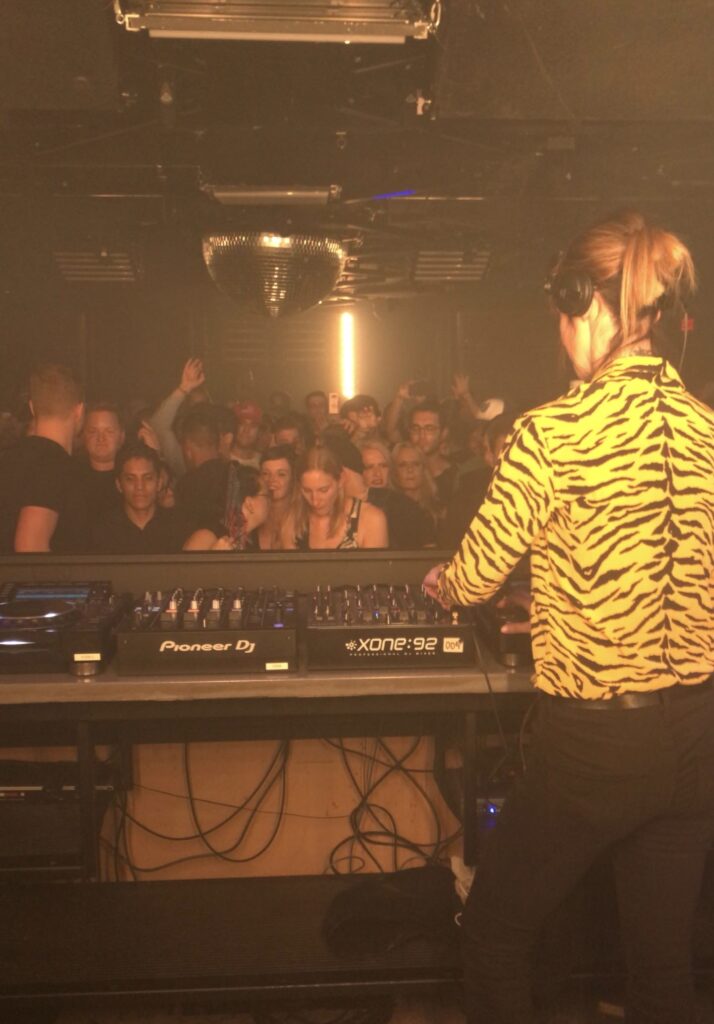 DJ play for a dense crowd amongst a disco ball at Coda Nightclub in Toronto 