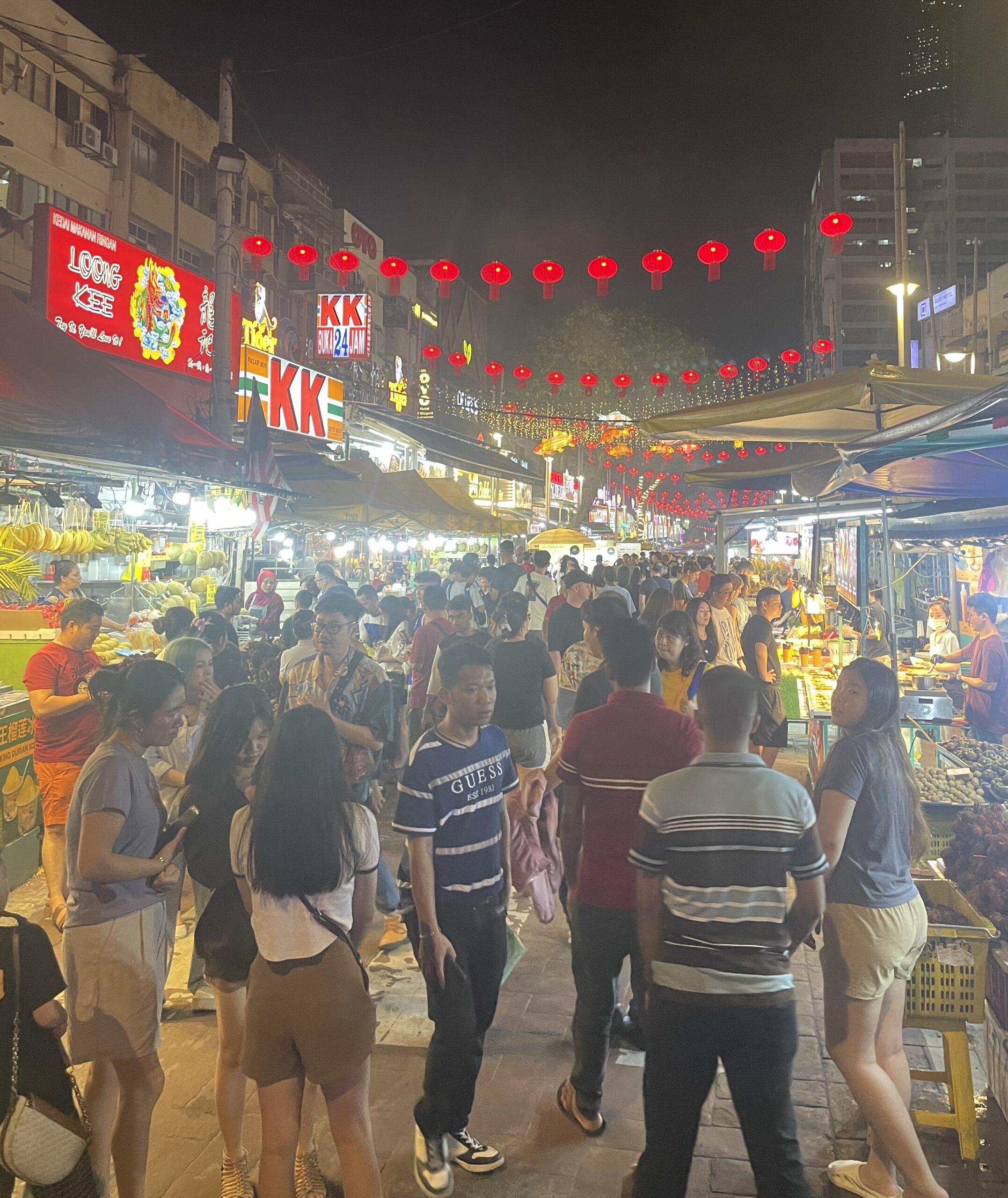 crowds walking by at the Jalan Night Market in Kuala Lumpur / Also known as the Jalan Alor Food Street