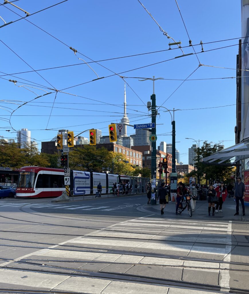 crowded intersection with many people crossing downtown Toronto