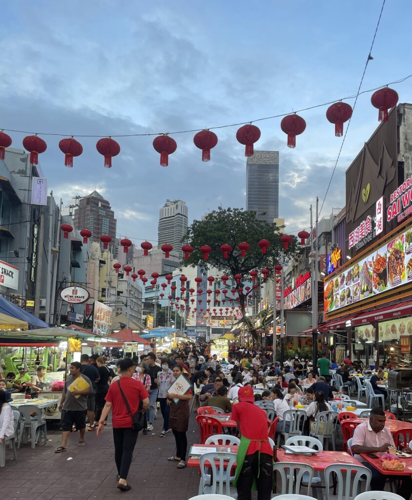several tourists and locals walking along the popular Jalan Alor Food Street