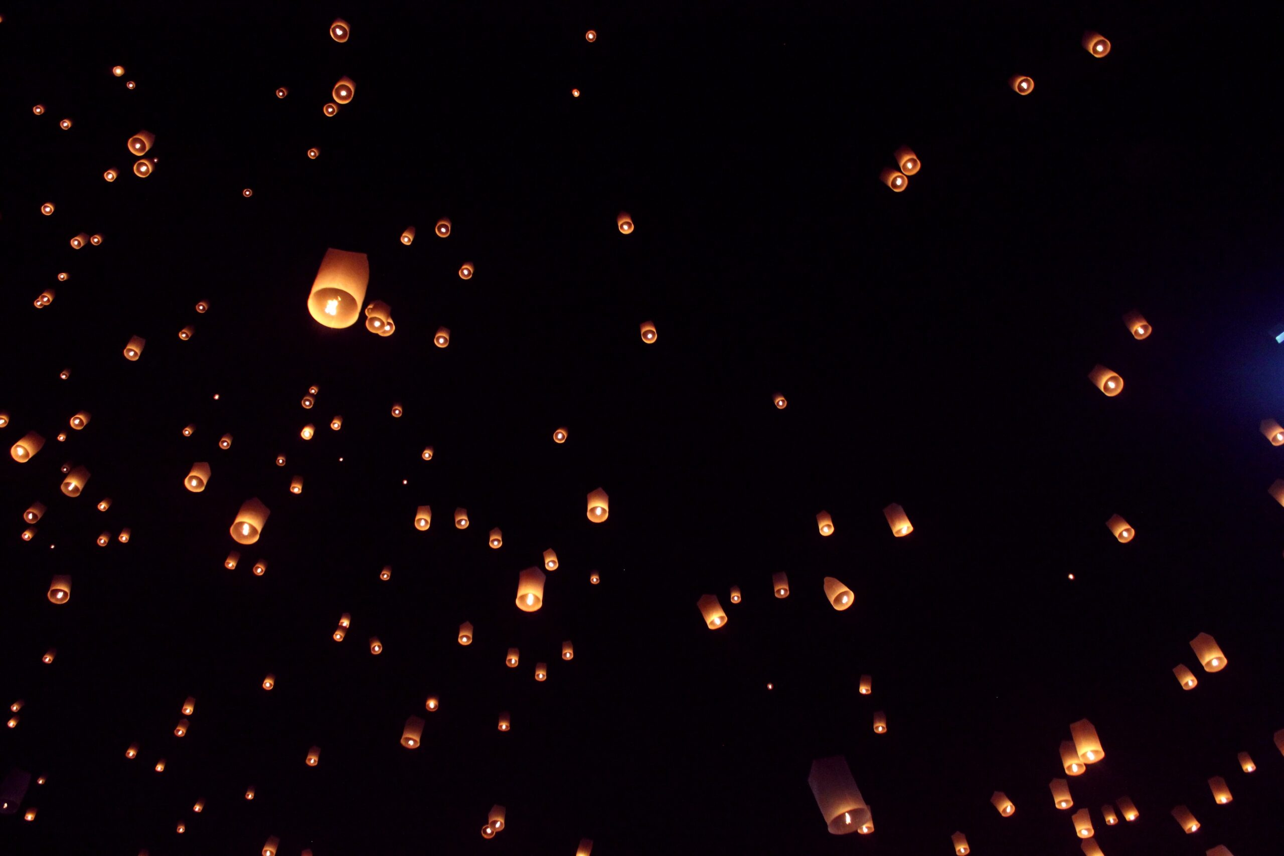 several illuminated lanterns in the sky during the lantern festival