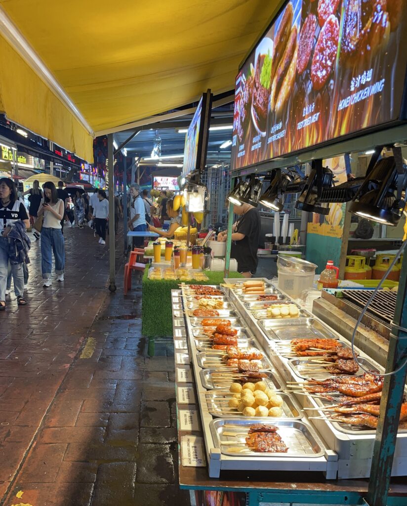 several meat skewers being sold by a vendor at the Jalan Alor Food Street in Kuala Lumpur